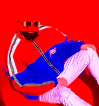 Stylized editorial photo of Nevv Evve reclining against a bright red backdrop wearing alternative fashion and oversized vintage streetwear.